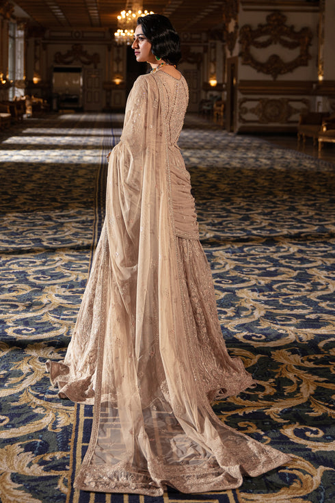 Side shot of Areeza showing flared lehanga silhouette, heavy embroidery panels and hanging embellishments cascading from sleeve edges.